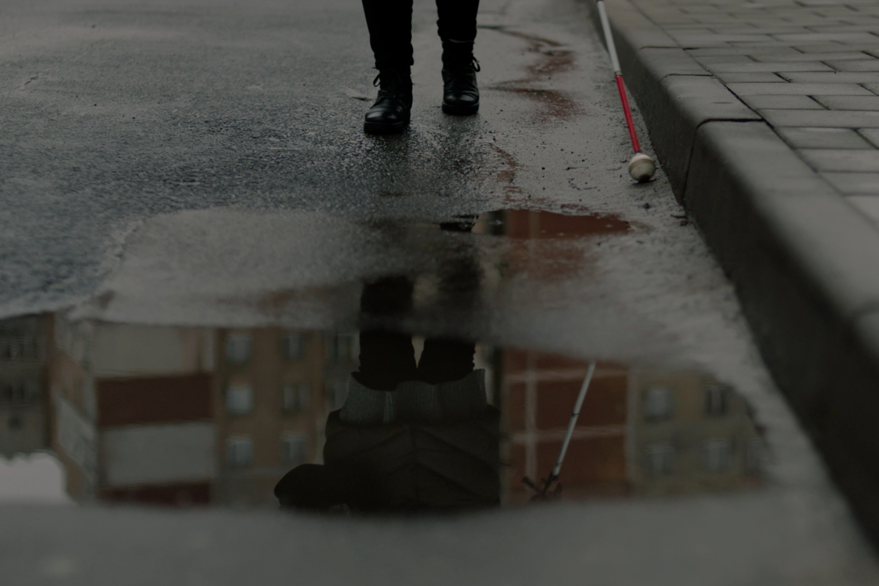 A person walking near a puddle